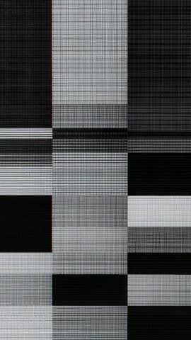 Vertical video shifting monochrome grid revealing stripe realignment and subtle glitch motion