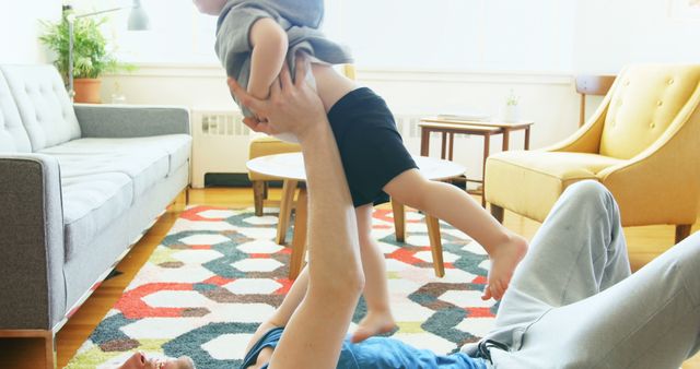 Father playing with child on living room floor in modern home - Download Free Stock Images Pikwizard.com