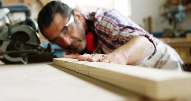 Focused Carpenter Measuring Wood Beam in Workshop - Download Free Stock Images Pikwizard.com