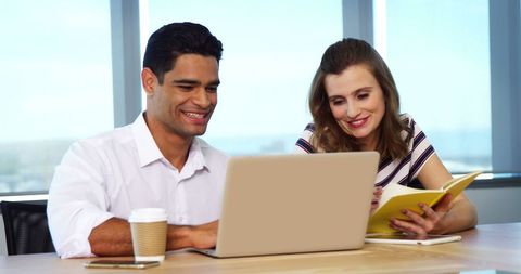 Happy Coworkers Collaborating on Project at Office Desk - Download Free Stock Images Pikwizard.com