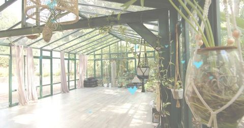 Sunlit glass sunroom with hanging planters, macrame, wood floor, airy minimalism