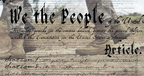 Soldier in Boots Symbolizing Defense and Patriotism over US Constitution