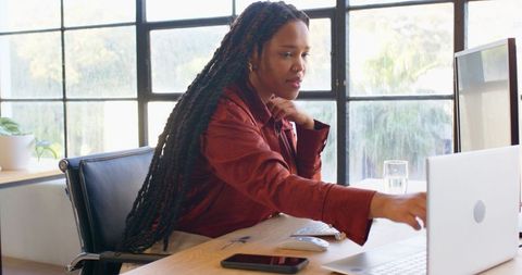 Focused Businesswoman Working on Desktop in Modern Office