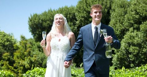 Joyful Bride and Groom Celebrating with Champagne in Garden Wedding