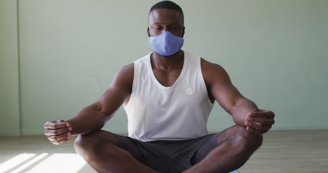 Man Meditating With Face Mask Indoors for Safe Yoga Practice - Download Free Stock Images Pikwizard.com