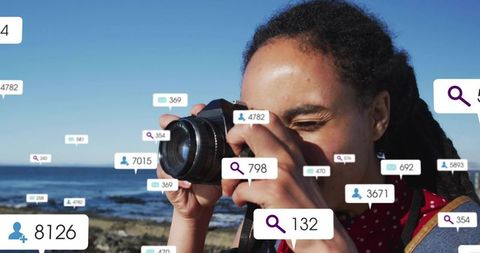 Female photographer shooting coastal seascape dslr with social media engagement tag overlays