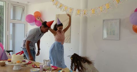 Family Celebrating Birthday with Laughter and Cake at Home