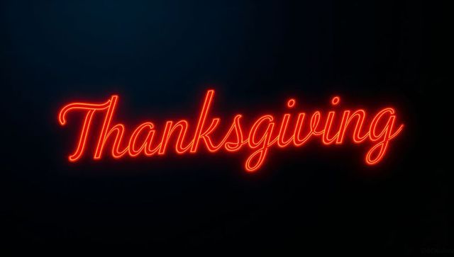 Glowing Thanksgiving Neon Sign on Dark Wall with Red-Orange Script Glow