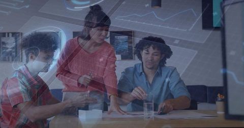 Collaborative Team Reviewing Printed Charts With Digital Data Visualization Overlay