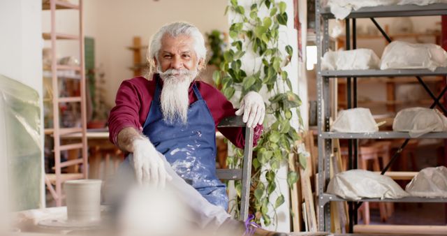 Meditative Moment for Aproned Senior Potter in Studio - Download Free Stock Images Pikwizard.com