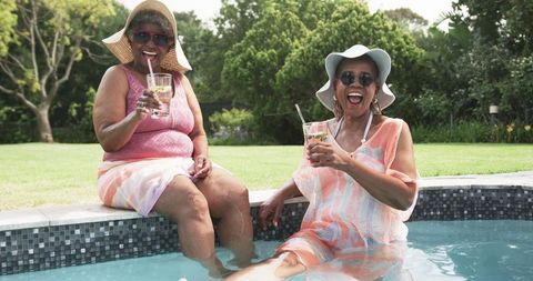 Senior Friends Enjoying Pool Time and Refreshing Drinks
