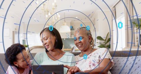 Multigenerational black family exploring augmented reality on tablet in living room