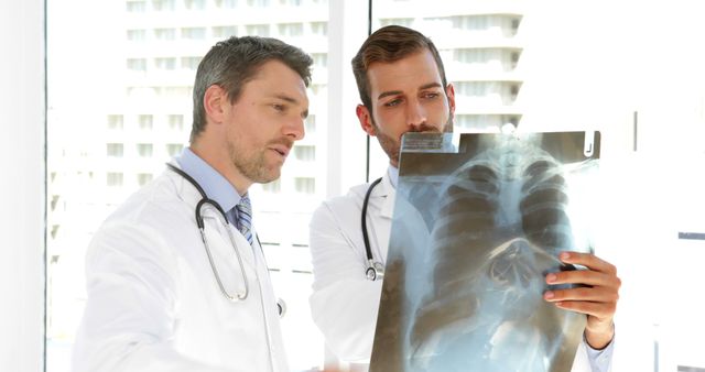 Medical Professionals Examining Chest X-ray in Hospital, Discussing Diagnosis - Download Free Stock Images Pikwizard.com