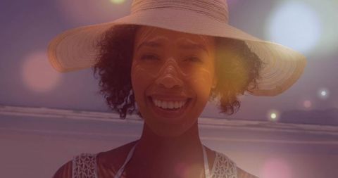 Joyful Woman in Straw Hat Enjoying a Sunny Beach Day
