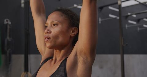 Dedicated Woman Engaging in CrossFit Workout at Gym