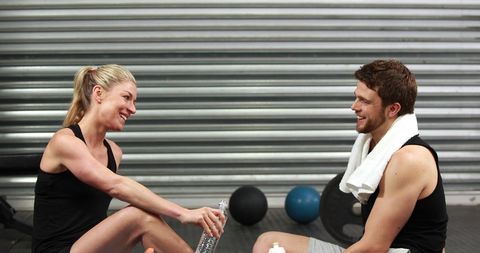 Fitness Enthusiasts Enjoying Break After Intense Workout Session