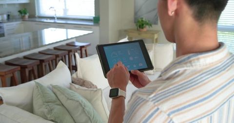 Controlling Smart Home with Tablet and Smartwatch in Modern Living Room