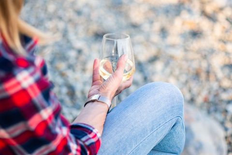Woman sitting outdoors relaxing with wine glass