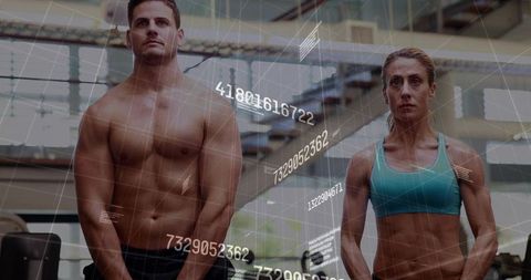 Athletic duo training in gym with biometric data overlays for fitness analytics insights
