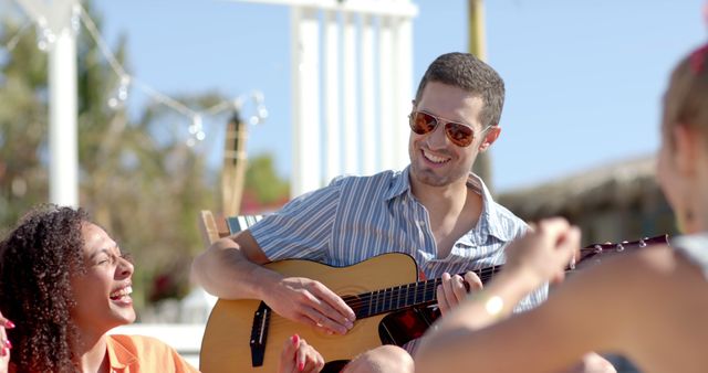 Group of Friends Enjoying Beachside Guitar Session - Download Free Stock Images Pikwizard.com