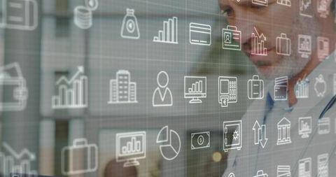 Executive Analyzing Floating Financial Icons in Office Environment