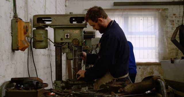 Male machinist working with drill press in factory workshop - Download Free Stock Images Pikwizard.com