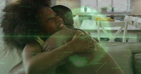 Father and daughter hugging on sofa with green hud overlay, home family tech connection