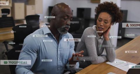Business team collaborating with augmented reality data overlays in modern open office