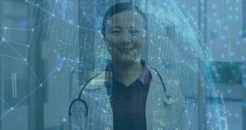 Asian Doctor with Stethoscope and Digital Interface in Hospital Corridor