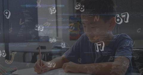 Young boy studying amidst alphabet and numbers in classroom