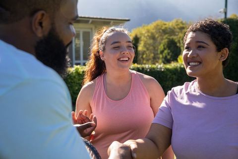 Diverse Friends Enjoying Tennis Outdoors for Fitness and Fun