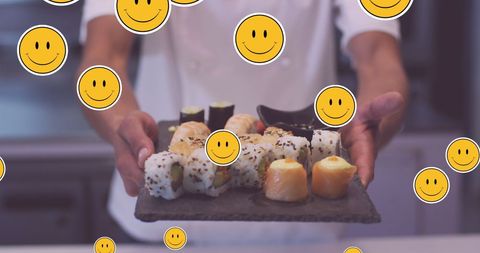 Chef presenting sushi platter with floating emojis