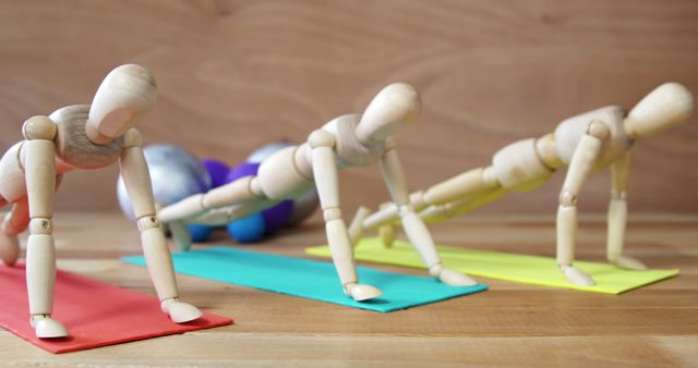 Wooden Mannequins Practicing Yoga Poses on Colorful Mats - Download Free Stock Images Pikwizard.com