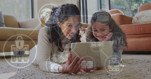 Mother and Daughter Exploring Tablet with Digital Security Icons in Living Room
