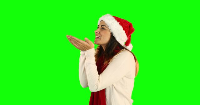 Woman Blowing Kiss Wearing Santa Hat Isolated on Green Background - Download Free Stock Images Pikwizard.com