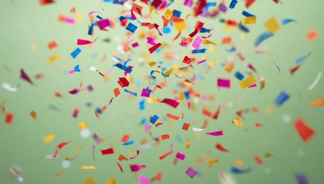 Vibrant Multicolored Confetti on Pastel Green Background