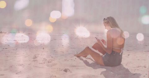 Woman Relaxing on Sunny Beach with Smartphone Outdoors