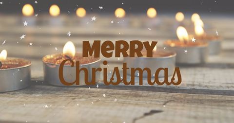 Merry christmas text with warm candlelit ambience