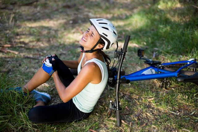 Injured Woman Sitting Next to Bicycle in Forest - Download Free Stock Photos Pikwizard.com