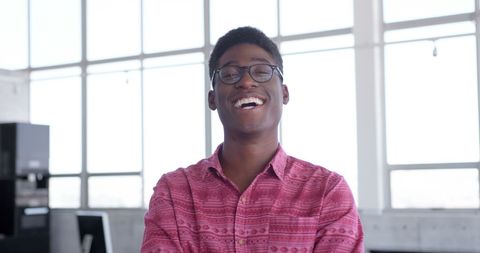 Confident Young Man Smiling in Modern Office Setting - Download Free Stock Images Pikwizard.com