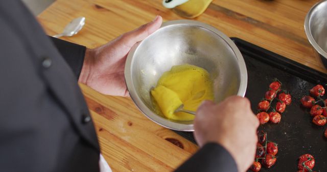 Chef preparing egg mixture in kitchen with roasted cherry tomatoes - Download Free Stock Images Pikwizard.com