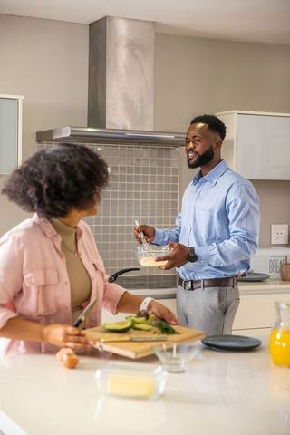 Couple Preparing Breakfast in Modern Home Kitchen