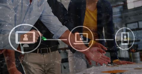 Diverse Team Collaborating in Modern Office with Digital Icons Overlay