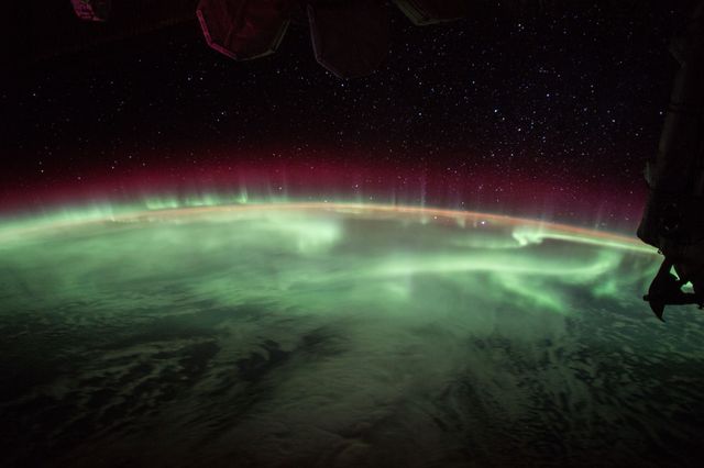 Image shows dynamic aurora on Earth captured from International Space Station on June 25, 2017. Vivid colors illuminate the night sky. Excellent for illustrating atmospheric phenomena, space exploration, NASA missions, natural beauty of Earth, educational materials on auroras, and the International Space Station mission highlights.
