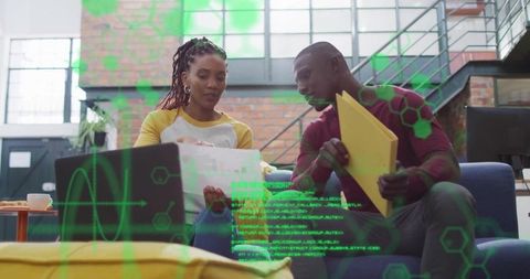 Colleagues reviewing documents in modern creative workspace