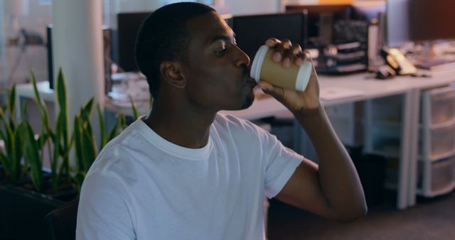 Man Drinking Coffee in Modern Office Environment - Download Free Stock Images Pikwizard.com