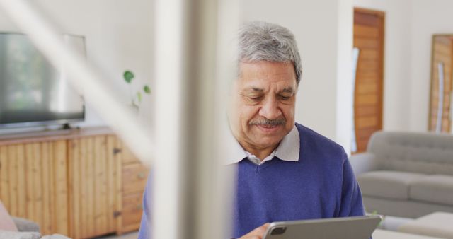 Senior Man Using Tablet in Modern Living Room - Download Free Stock Images Pikwizard.com