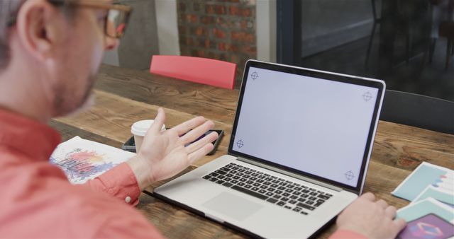 Man working on laptop showing blank screen in modern office - Download Free Stock Images Pikwizard.com