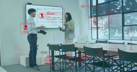 Business professionals confronting cybersecurity breach during boardroom presentation with red alert