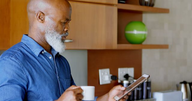 Senior African American Man Reading Digital Tablet in Kitchen - Download Free Stock Images Pikwizard.com